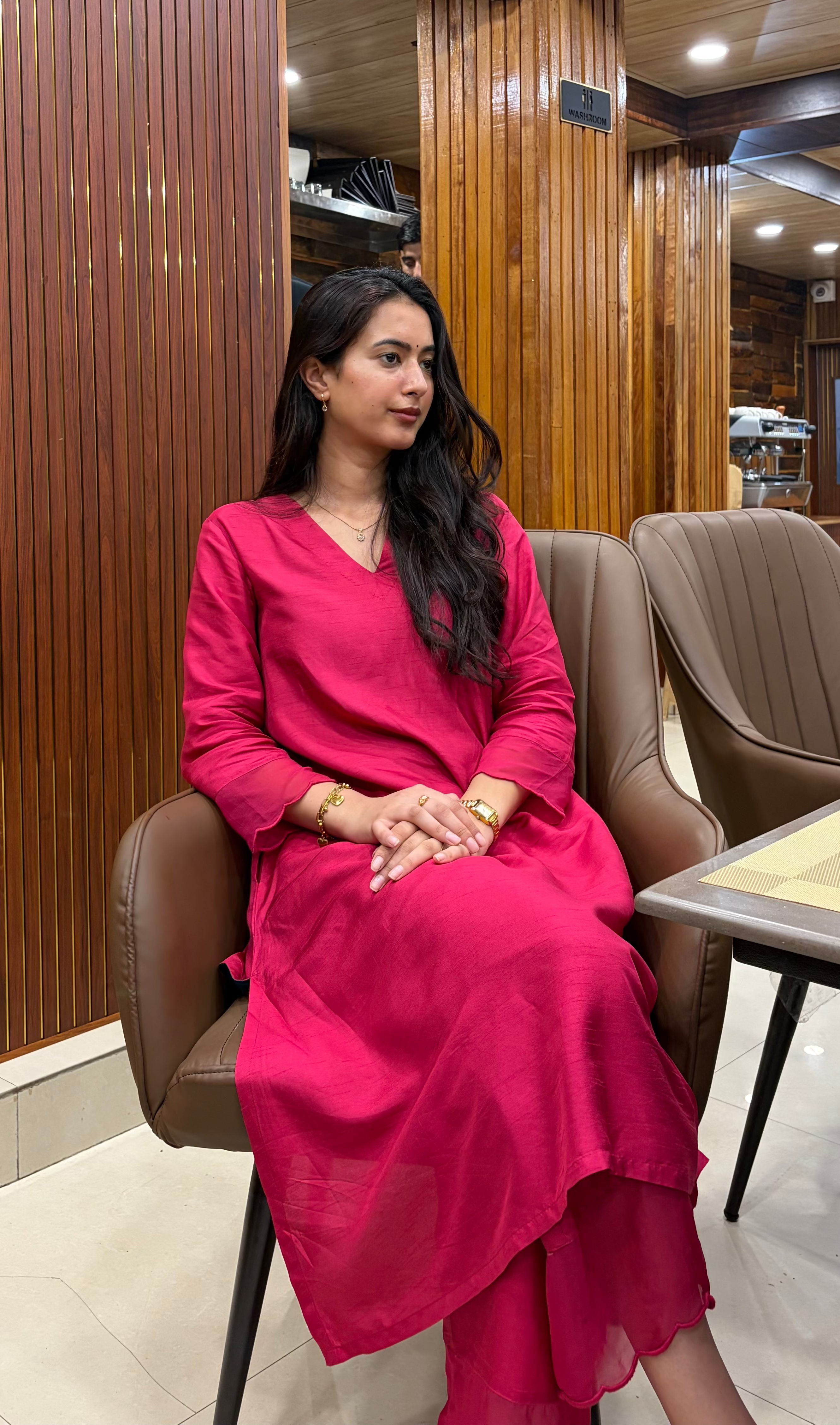 A woman wearing a bhuweave vibrant magenta-pink long-sleeve kurta pant set 