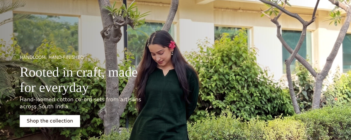 A woman wearing a dark green cotton kurta walks outdoors in a garden setting with trees and a building in the background. Text overlays on the left read 'Rooted in craft, made for everyday' and 'Shop the collection'.